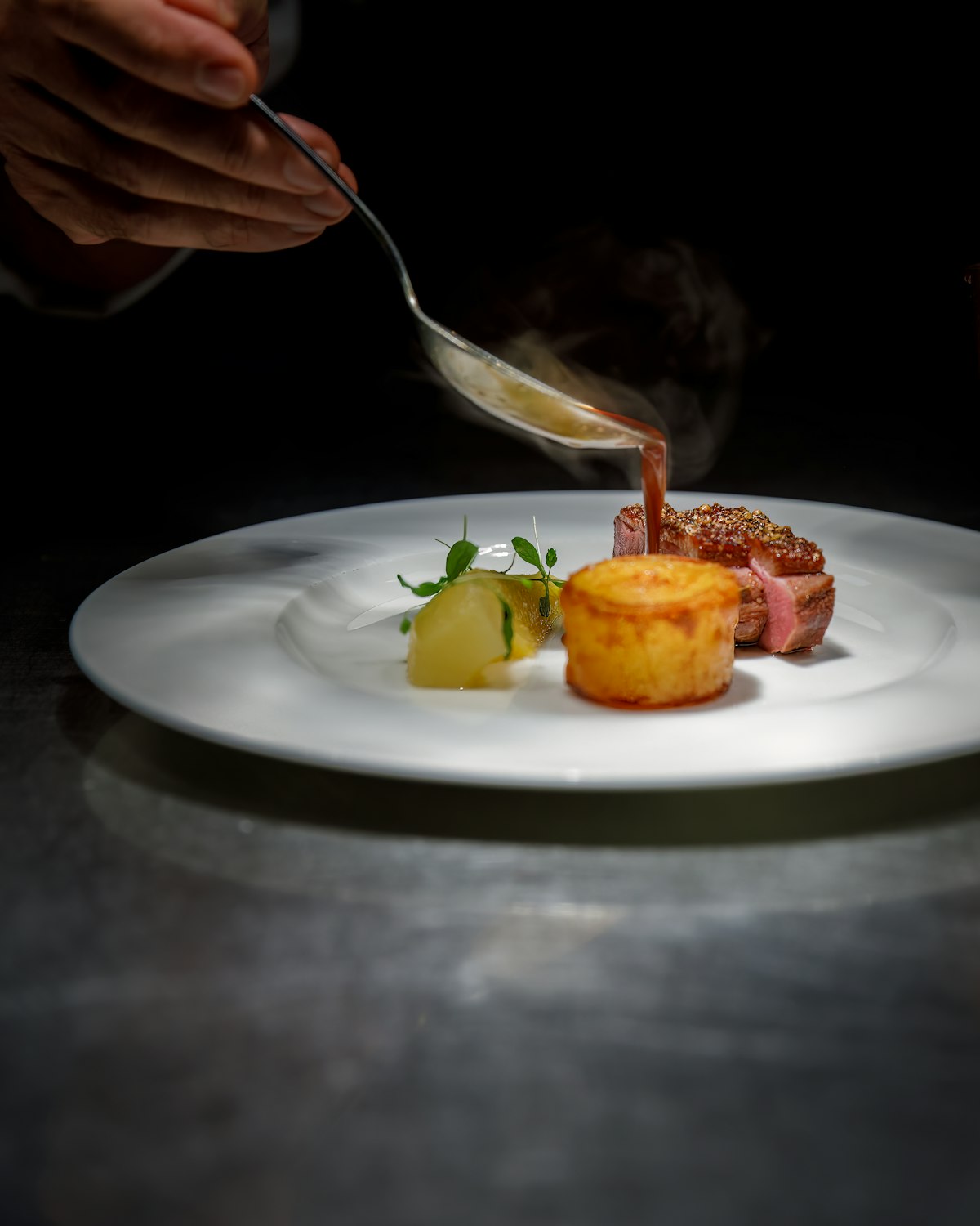 Sauce being spooned over a finished dish, close-up